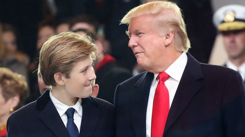 Barron Trump looking at Donald Trump at an event