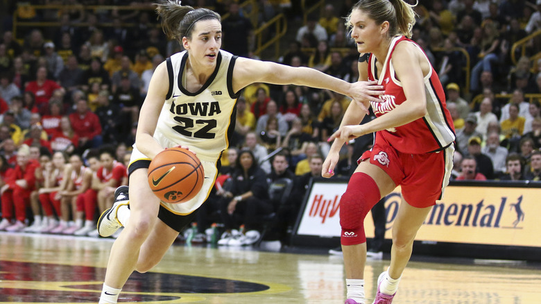 Caitlin Clark moves past Jacy Sheldon during game