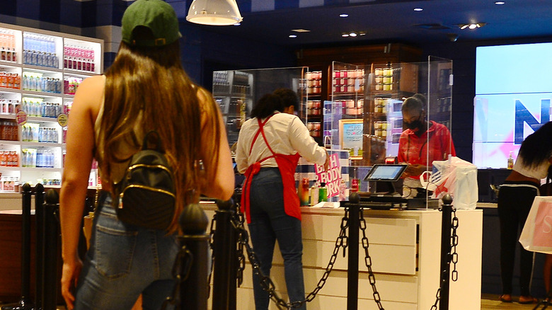 Cashier handing customer a bag