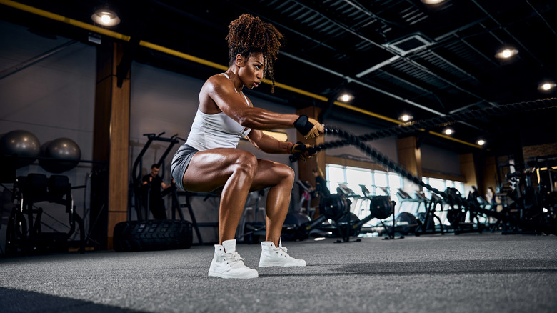 Woman using battle ropes