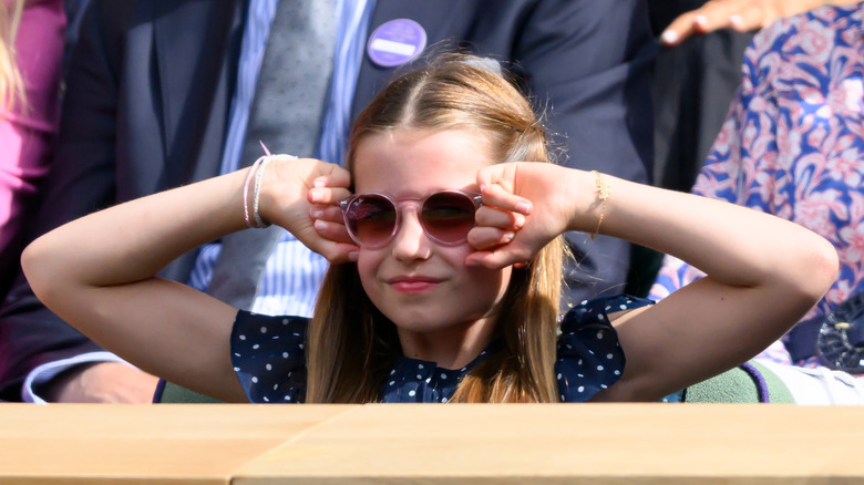 Princess Charlotte hands up smiling sunglasses