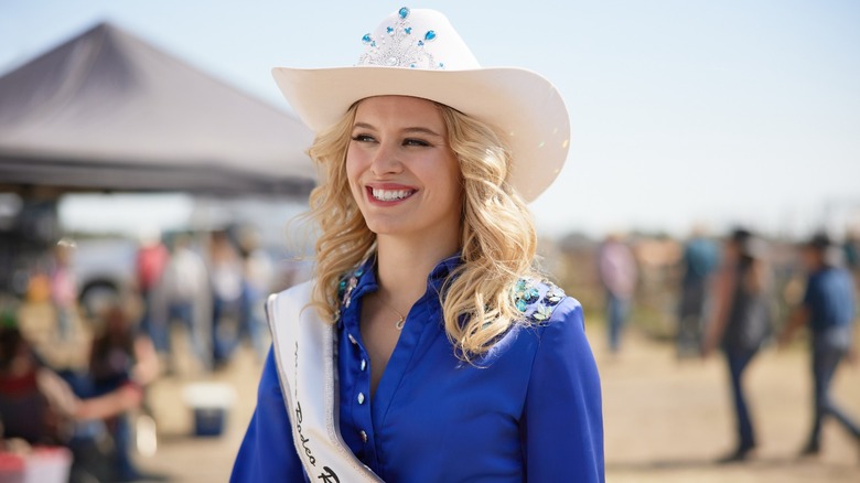 Missy wearing cowboy hat and sash in Ride