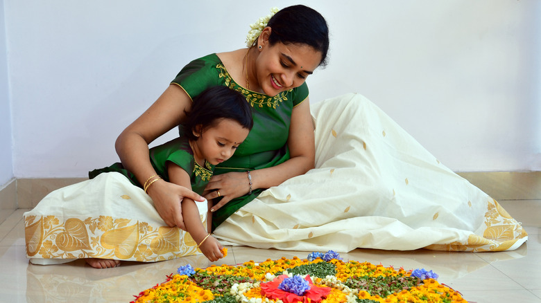 Mother, daughter arranging flowers