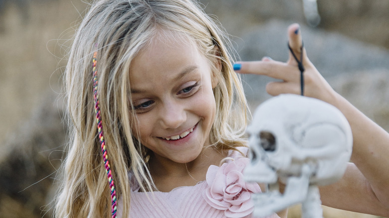 Young girl holding a skull