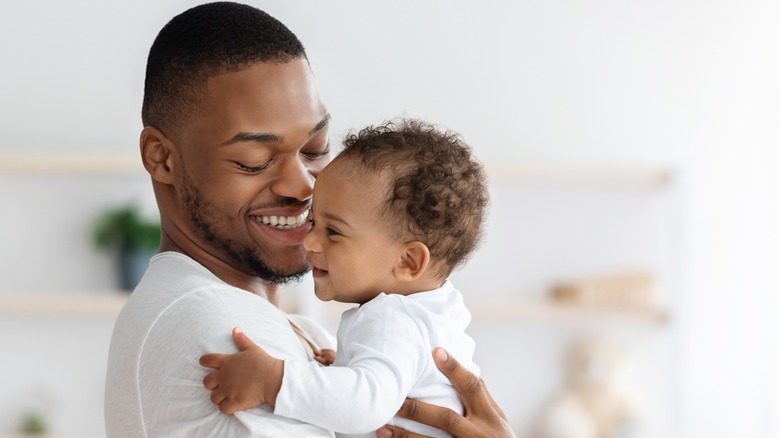 Baby boy being held by father