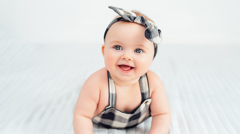 Baby girl smiling during tummy time