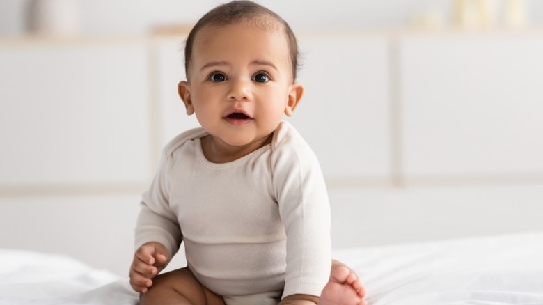 Baby in a onesie smiling