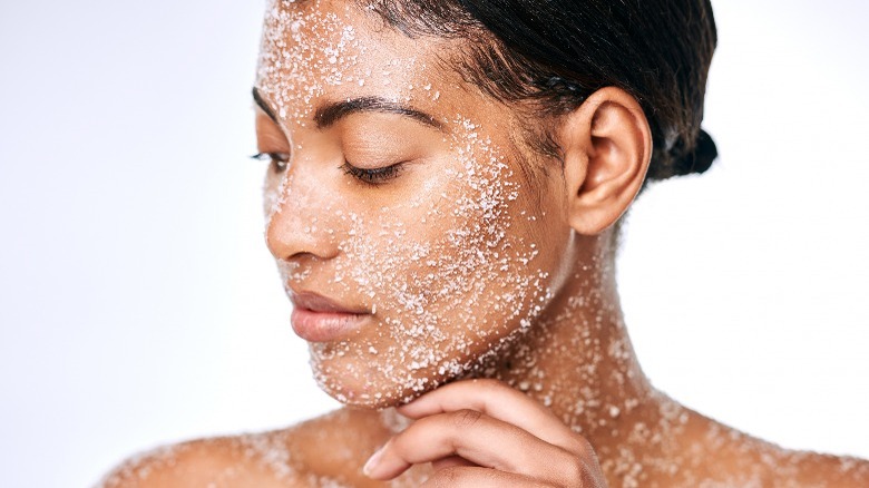 Woman using face scrub