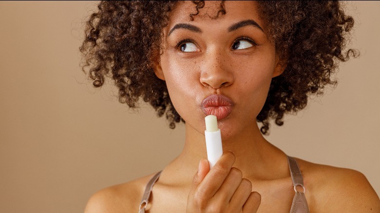 Woman using chapstick