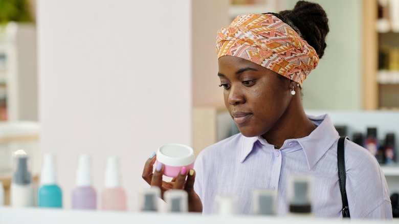 Woman choosing a beauty product in a store