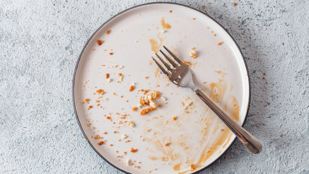 dirty plate with crumbs and fork