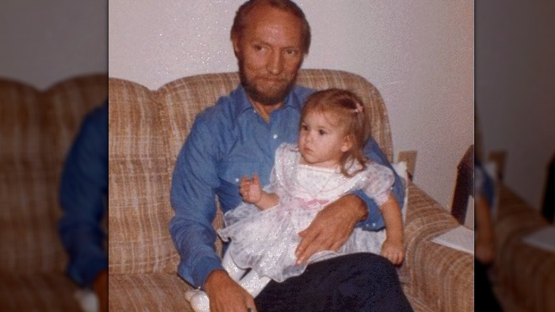 Brandi Passante as a child sitting on the lap of a family member