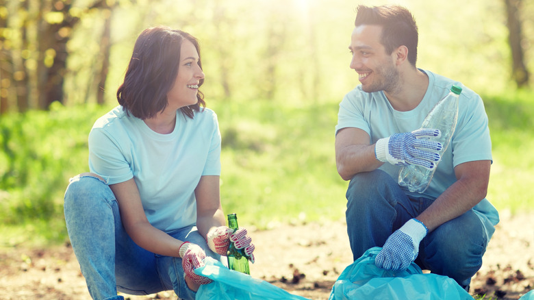 two people volunteering to pick up trash