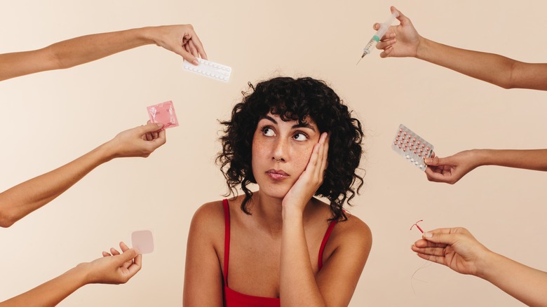 A woman overwhelmed by birth control options