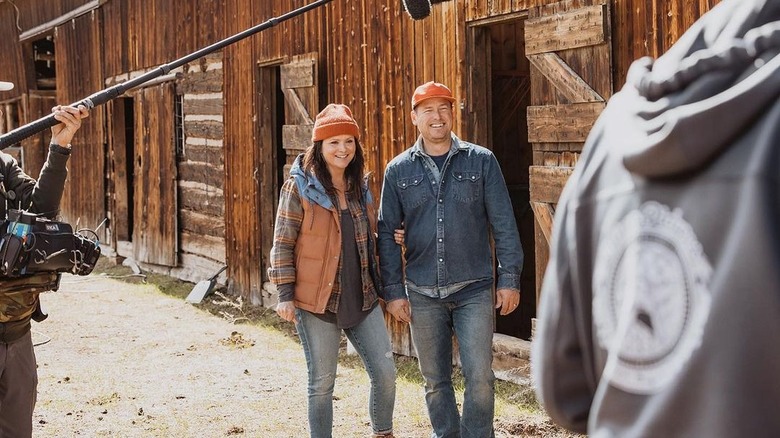 Ben and Cristi Dozier filming by barn