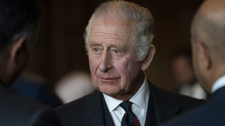 King Charles III engaging in conversation