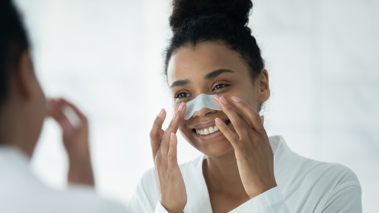 Woman using biore strip