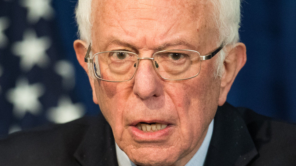 Bernie Sanders giving a speech in glasses