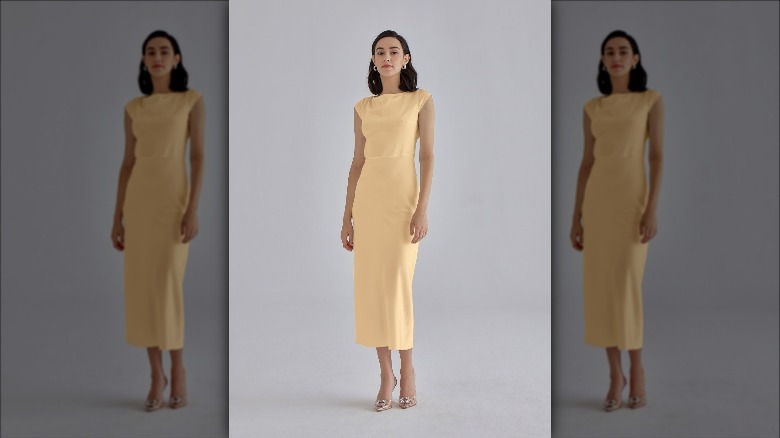 Silk Maison model wears marigold dress