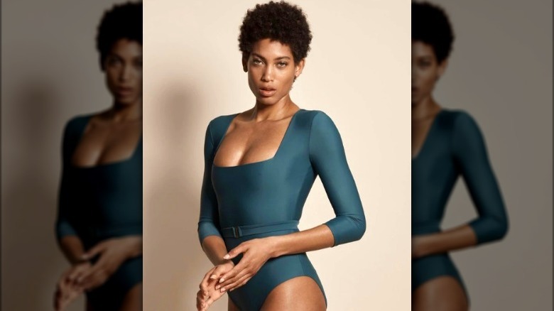 Black model wearing green long sleeve swimsuit