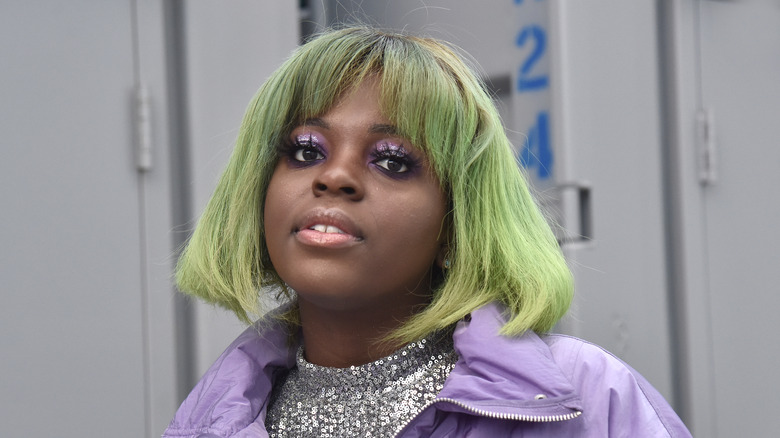 Kah-lo performing with a lime green hairstyle