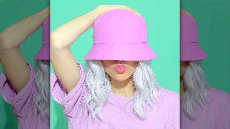 woman wearing bucket hat puckering up