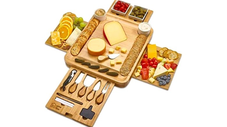 Multi-level wooden charcuterie board with meats and cheese