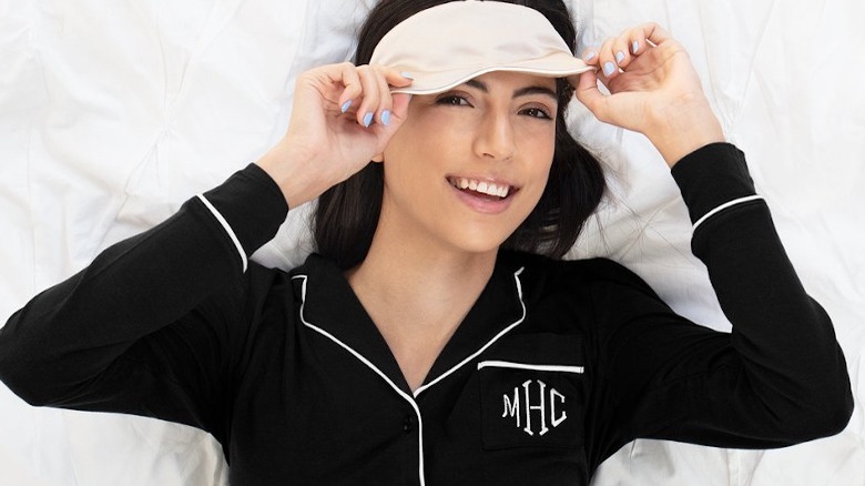 Woman in black pajamas and sleep mask