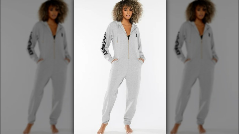 Woman wearing a gray onesie pajama