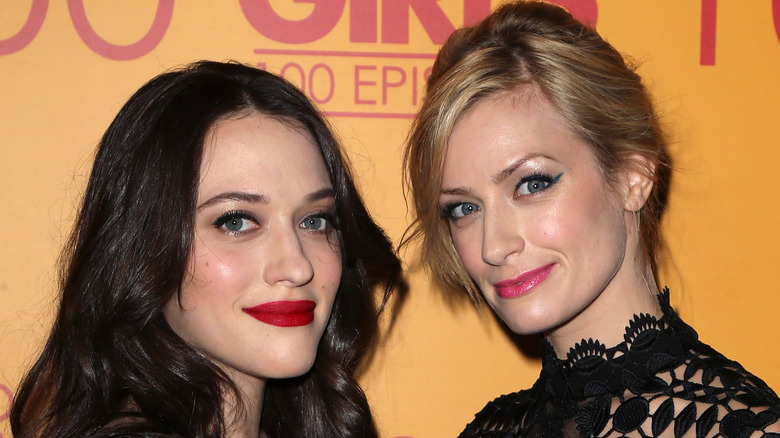 Beth Behrs, Kat Dennings posing on red carpet