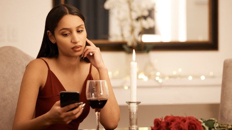 Woman on phone during date