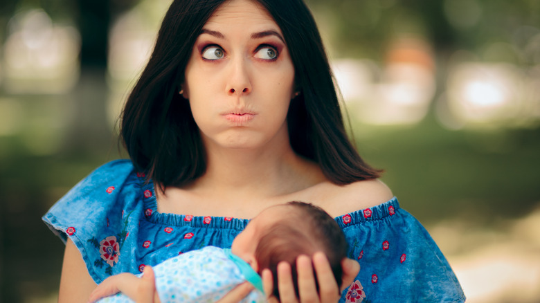 Nervous babysitter with infant