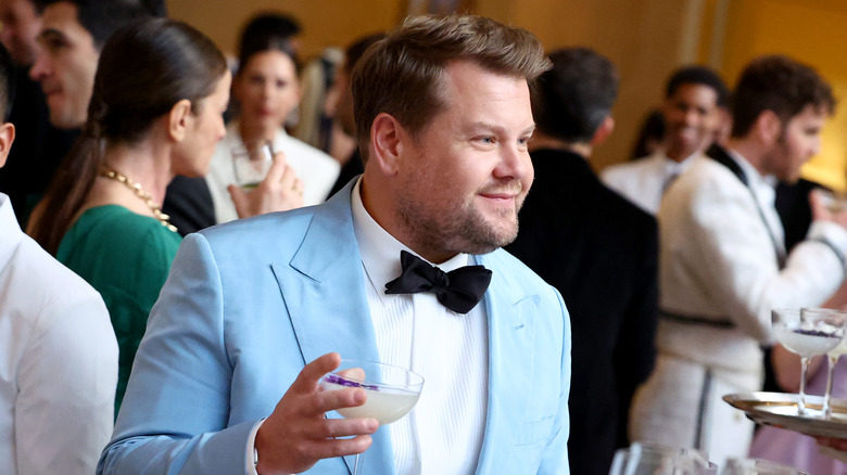 James Corden holding glass