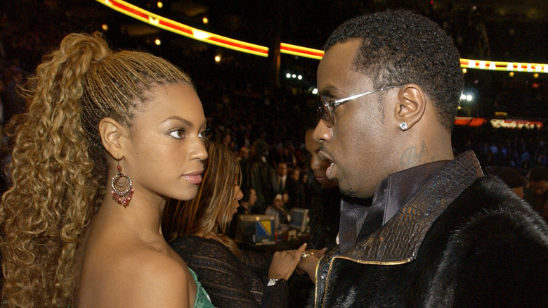 Diddy and Beyonce looking at each other.