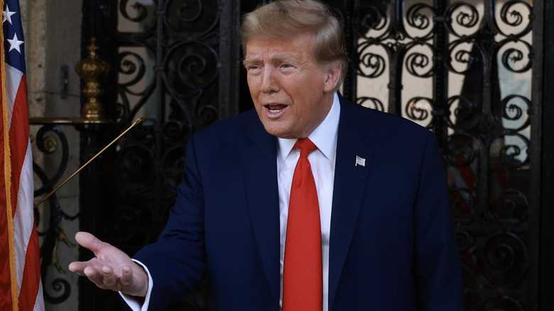 Donald Trump speaking, hand outstretched