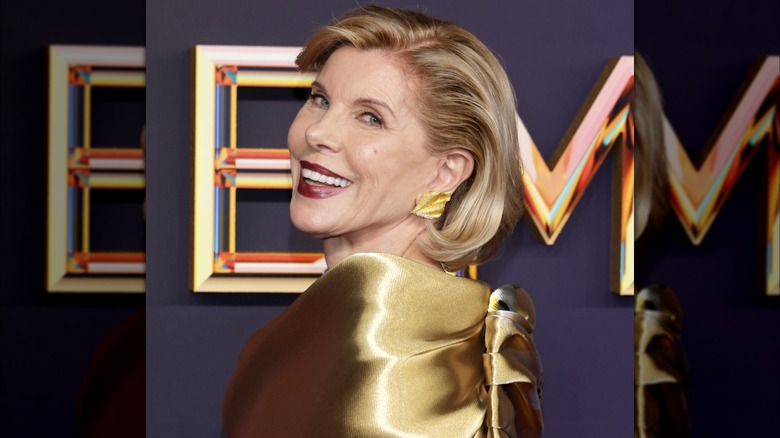 Christine Baranski smiling in a gold dress