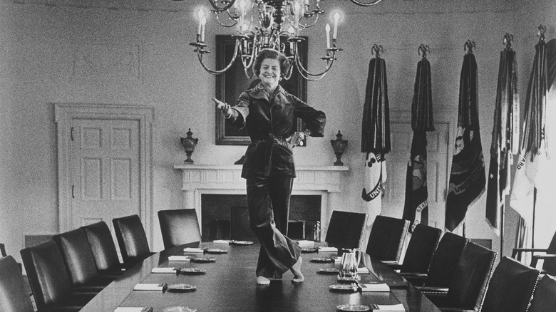 Betty Ford dancing on table in pants.