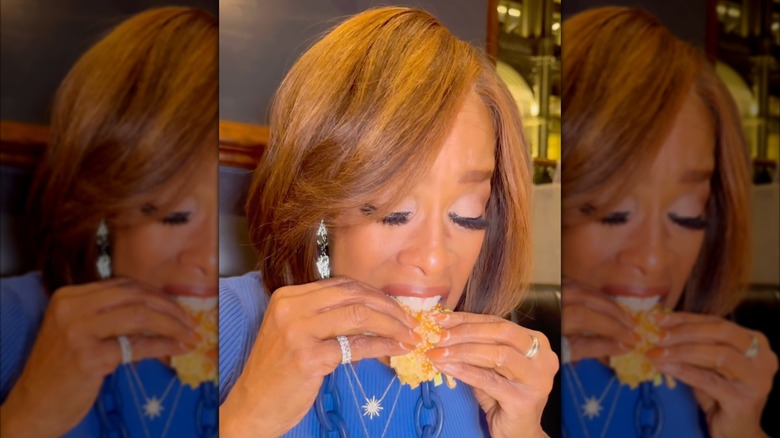 Gayle King eating a burger