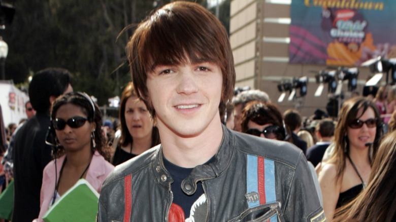 Young Drake Bell posing at event