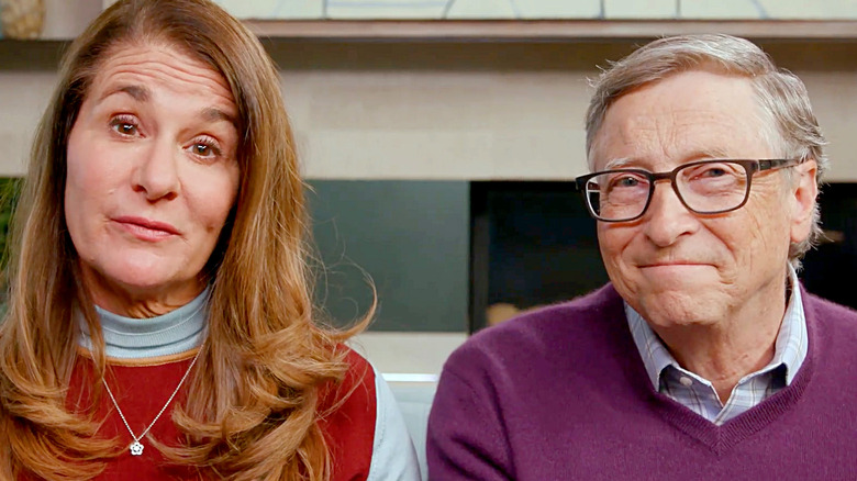 Melinda Gates wears a blue and red sweater with Bill Gates in purple.