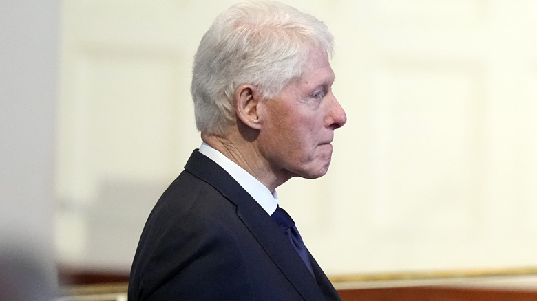 Bill Clinton standing to the side