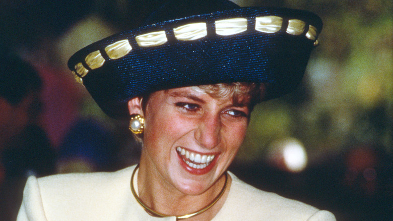 Princess Diana smiles during an event. 