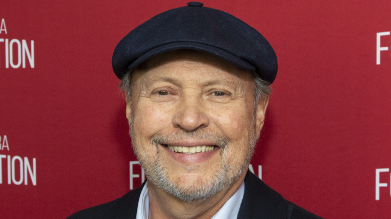 Billy Crystal smiling, wearing beret