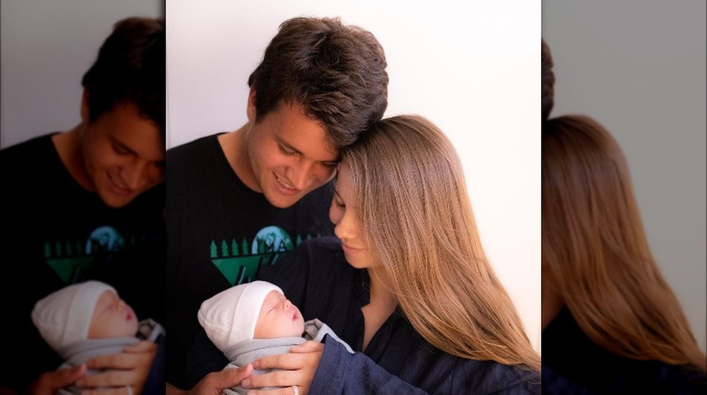 Bindi Irwin, Chandler Powell, and baby Grace pose together