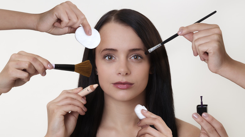 Woman getting makeup appiled