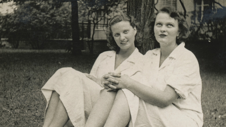 Two women sitting on lawn, 1955