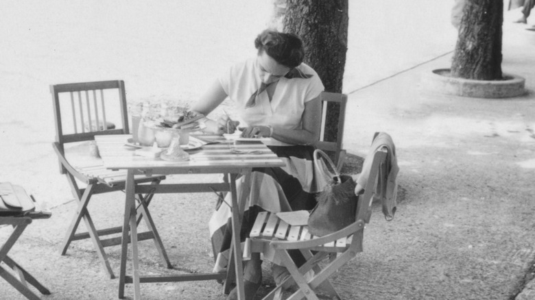 Woman sitting at a cafe, 1950s