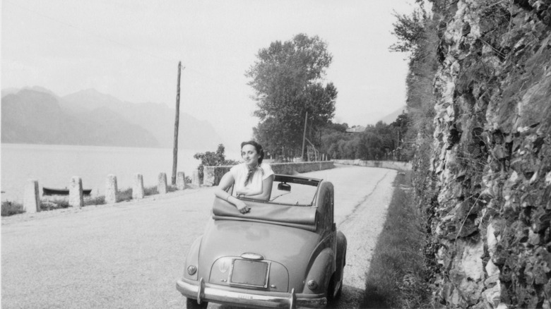 woman sitting in car, 1950s