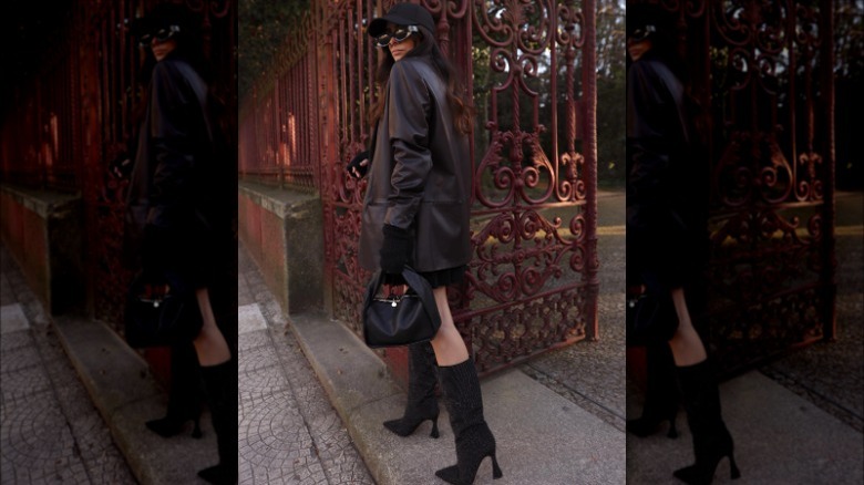 woman posing in black and brown outfit