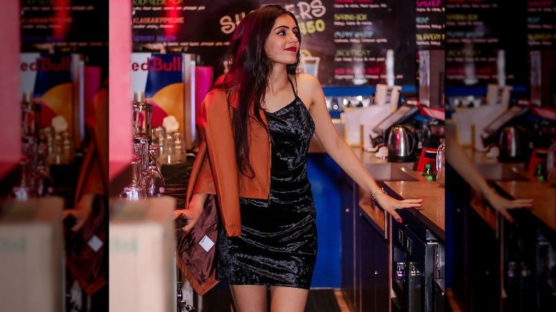 woman in black dress in bar